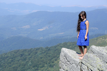Naklejka premium Small girl in mountains