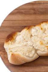 Pastry stuffed with cheese on the wooden board