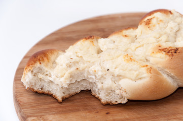 Pastry stuffed with cheese on the wooden board