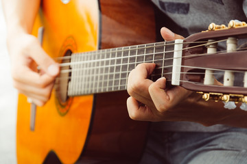  hand playing on  guitar