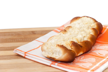 Bakery bun stuffed with cheese on the wooden board
