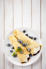 Crepes with blueberries and cream