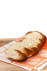 Bakery bun stuffed with cheese on the wooden board