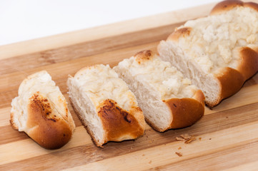 Pastry stuffed with cheese sliced on the wooden board