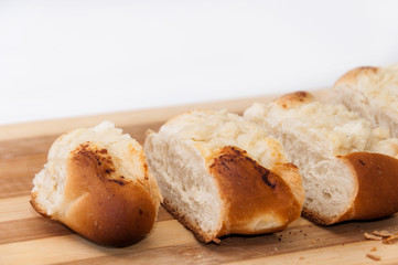 Pastry stuffed with cheese sliced on the wooden board