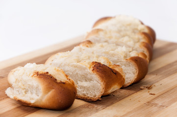 Pastry stuffed with cheese sliced on the wooden board