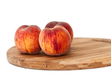 Fresh peaches on the kitchen wooden board