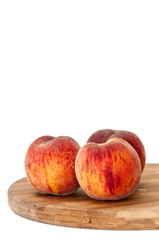 Fresh peaches on the kitchen wooden board
