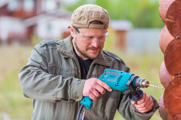Worker with a drill