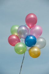 multicolored balloons on blue sky