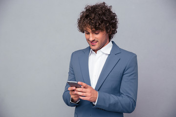 Portrait of a happy businessman using smartphone