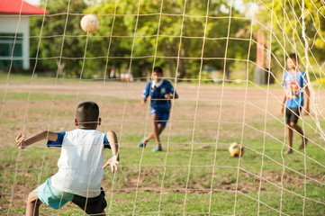 kids playing football on bad field