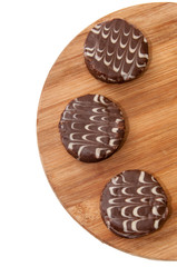 Three chocolate muffins on the wooden board