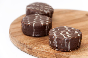 Three chocolate muffins on the wooden board