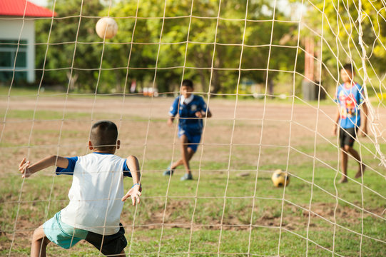 Kids Playing Football On Bad Field