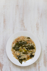 greens with smoked portuguese sausage and rice on white plate