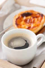cup of coffee with portuguese cookie pasteis de nata