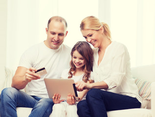 Fototapeta premium parents and girl with tablet pc and credit card