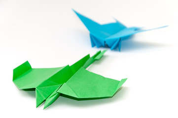Bunch of origami jet airplanes over white background