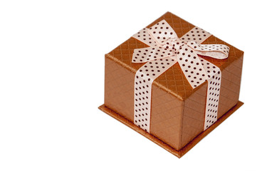 Closed golden gift box with bow over white