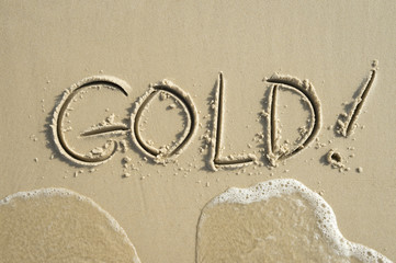 Simple gold message handwritten in clean text on smooth sand beach in Rio de Janeiro Brazil