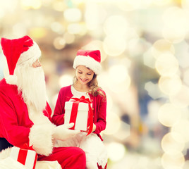 smiling little girl with santa claus and gifts
