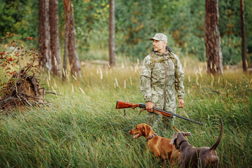 yang Hunter with Rifle and Dog in forest