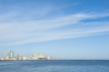 Fototapeta na wymiar Havana Cuba daytime skyline along the Malecon waterfront with the Caribbean Sea under bright blue sky