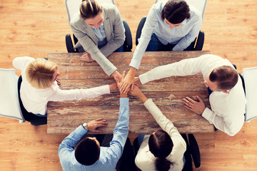 close up of business team with hands on top