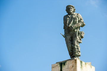 Statue of Cuban revolutionary Che Guevara stands in blue sky at a mausoleum dedicated to him and...