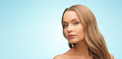 Naklejka premium beautiful young woman face over blue background
