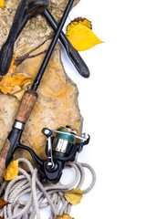 fishing rods on stones with anchor and leafs