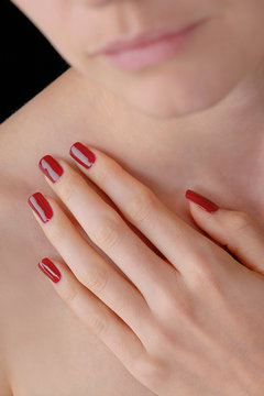 Young beauty with lacquered red nails