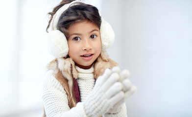 happy little girl wearing earmuffs