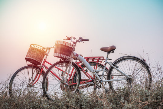 beautiful landscape image with two bicycle at sunset ; vintage f