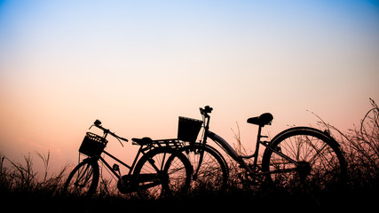 beautiful landscape image with Silhouette Bicycle at sunset in v