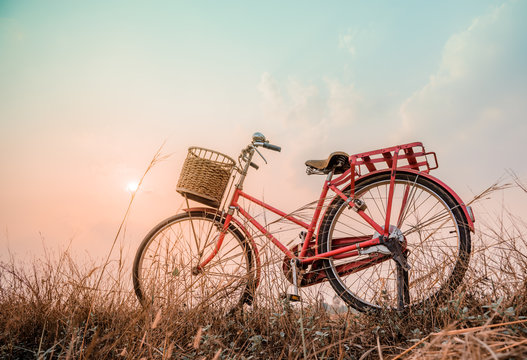 beautiful landscape image with Bicycle at sunset ; vintage filte