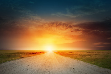 Sunrise above road