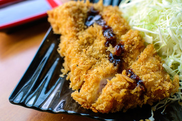 Tonkatsu deep fried pork cutlet serve with slice cabbage