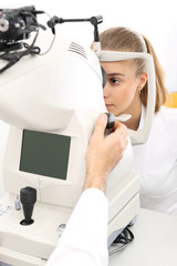 Kobieta u okulisty, komputerowe badanie wady wzroku, dobór soczewek kontaktowych © Robert Przybysz