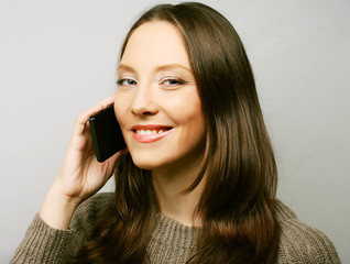 Woman using a mobile phone isolated on a white background