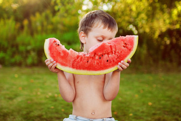 child eating watermelon
