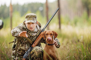 hunter with a dog on the forest