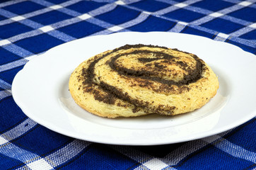 Homemade cake with poppy seeds in the shape of a snail