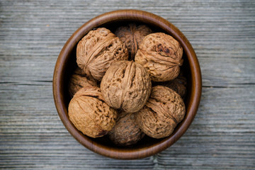 walnuts in a bowl - rustic wooden table