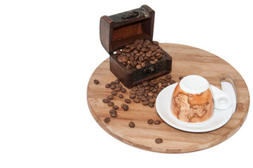 Wooden chest with coffee beans and coffee mug on the wooden boar