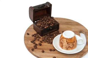 Wooden chest with coffee beans and coffee mug on the wooden boar