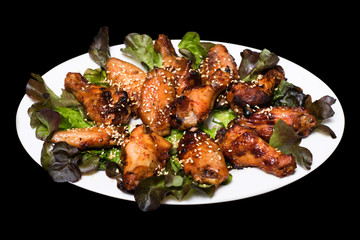 Photo of chicken thighs in honey sauce on a lettuce leaf