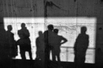 Men Shadows On The Concrete Wall
