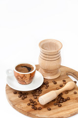 Cup of coffee with wooden mortar